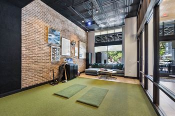 A living room with a brick wall and a large window
