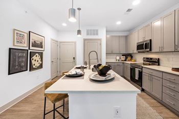 A kitchen with a white counter and a sink