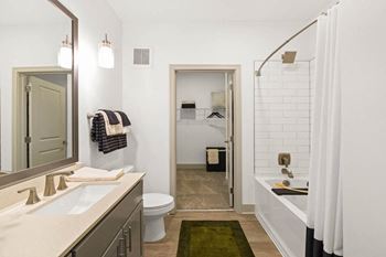 A bathroom with a sink and a toilet and a shower