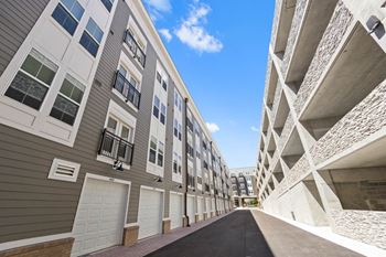 A row of apartment buildings with a street in the middle