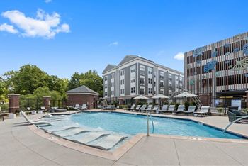 A swimming pool with a building in the background