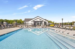 West Lafayette apartment for rent - A sparkling resort-inspired pool surrounded by lounge chairs and umbrellas, offering residents a relaxing outdoor retreat  at Montage West Lafayette Apartments, West Lafayette, Indiana