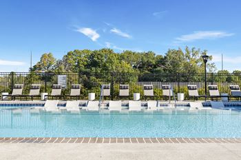 Poolside loungers line the modern swimming pool area at montage west lafayette, perfect for sunbathing and enjoying the indiana summer.