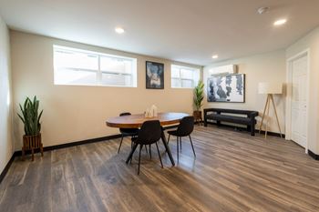 A dining room with a wooden table and chairs