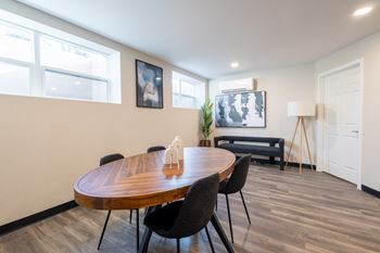 A dining room with a wooden table and chairs