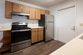 Terre Haute apartment for rent - a kitchen with a stove and refrigerator in a 555 waverly unit