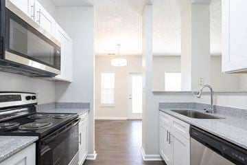 Avon apartment for rent - a kitchen with a stove and a sink and a microwave