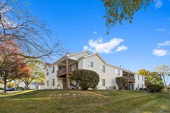 A building at the winds at poplar creek showcasing patio and balconies