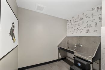 The laundry room has a stainless steel sink and a wall covered in martial arts drawings