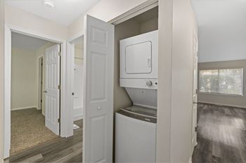 An empty laundry room with a washer and dryer in it