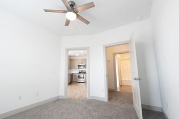 A bedroom with a ceiling fan