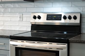 A kitchen with a stove top oven next to a counter