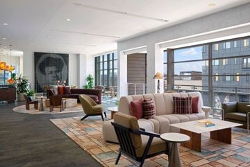 Indianapolis apartment for rent - A modern living room with a large window and a balcony.