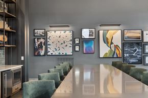 Indianapolis apartment for rent - Clubhouse at Nook Nine with modern artwork, sleek dining table, and plush seating.