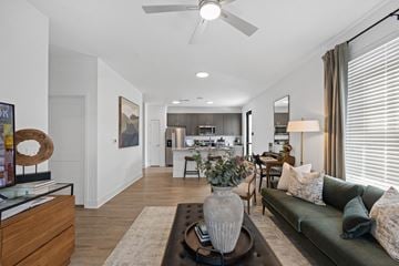 Indianapolis apartment for rent - A living room with a green couch and a coffee table with a vase on it.