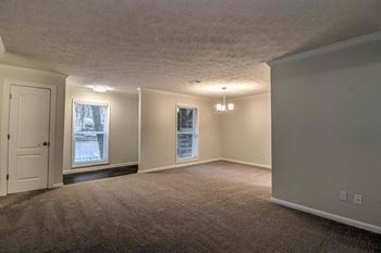 The living room and dining room of an empty home