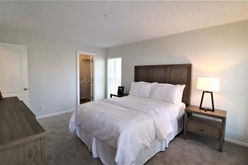 The master bedroom has a large bed and a closet