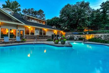 Night view of pool with clubhouse