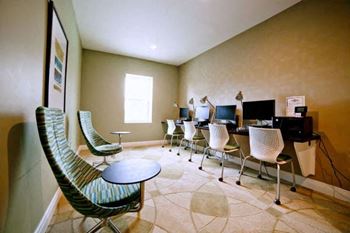 A room with a table and chairs and a television.