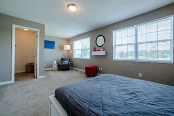 A bedroom with a large bed and a window.