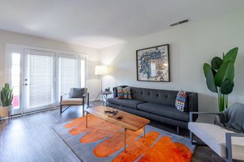 A living room with a grey couch and a coffee table.