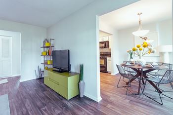 A room with a yellow cabinet and a television on it.