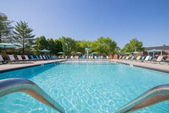 A large swimming pool with a metal railing in the foreground.