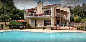 Nashville apartment for rent - a large swimming pool in front of a house at Landmark at Lyncrest Reserve Apartments, Nashville, 37209