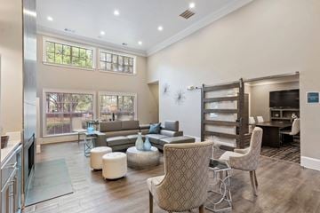Conyers apartment for rent - A living room with a grey sofa and a patterned armchair.