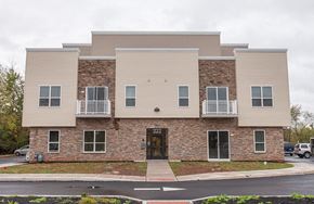 Warminster apartment for rent - the front of a brick apartment building with a sidewalk