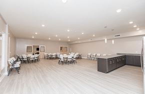 Warminster apartment for rent - the multipurpose room with tables and chairs and a kitchen