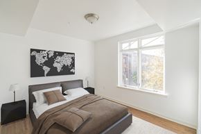 Philadelphia apartment for rent - a bedroom with a bed and a world map on the wall
