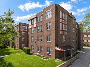 Bryn Mawr apartment for rent - A large brick building with a red and white striped building in the background.