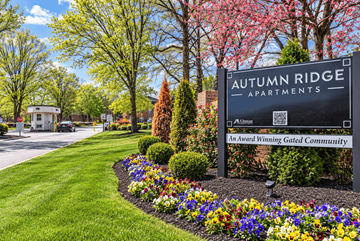 Blackwood apartment for rent - A sign for Autumn Ridge Apartments is surrounded by flowers and greenery.