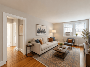 Bryn Mawr apartment for rent - A living room with a white couch, a coffee table, and a painting on the wall.