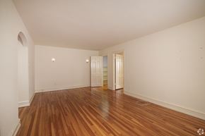 Bryn Mawr apartment for rent - A room with wooden floors and white walls.