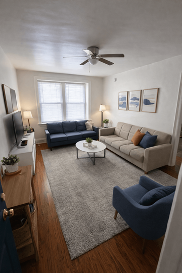 Philadelphia, Pa apartment for rent - A living room with a blue chair and a grey rug.