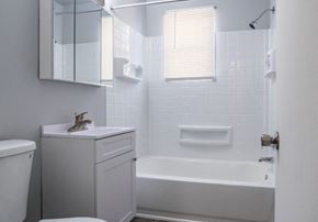 Philadelphia apartment for rent - A white bathroom with a toilet, sink, and bathtub.