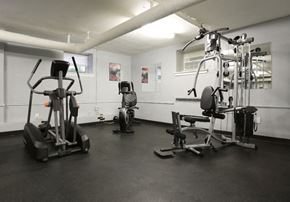 Wilmington apartment for rent - A gym with a treadmill, a stationary bike, and a weight machine.