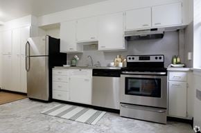 Wilmington apartment for rent - A modern kitchen with stainless steel appliances and white cabinets.