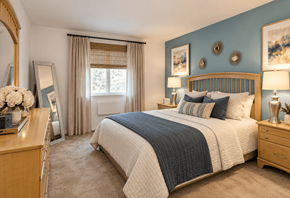 Philadelphia apartment for rent - A bedroom with a large bed, a dresser, and a mirror.