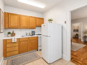 Bryn Mawr apartment for rent - A kitchen with wooden cabinets and a white refrigerator.