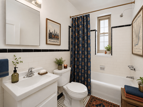 Bryn Mawr apartment for rent - A bathroom with a white sink, toilet, and bathtub.
