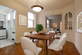 Wilmington apartment for rent - A dining room with a wooden table and white chairs.