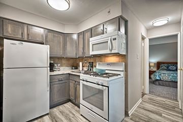 Feasterville apartment for rent - A kitchen with a white refrigerator, stove, and microwave.