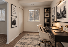 Philadelphia apartment for rent - A room with a desk, chair, and framed pictures on the wall.
