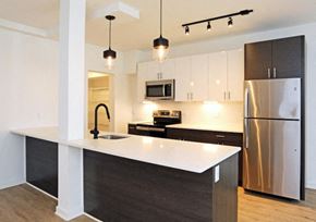 Philadelphia apartment for rent - a kitchen with stainless steel appliances and a white counter top