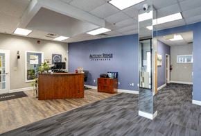 Blackwood apartment for rent - The lobby of Autumn Ridge Sportsplex with a reception desk and a glass door.