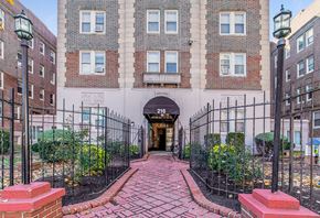 Philadelphia apartment for rent - A brick pathway leads to a black iron gate entrance.