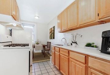 Philadelphia apartment for rent - A kitchen with wooden cabinets and a white oven.